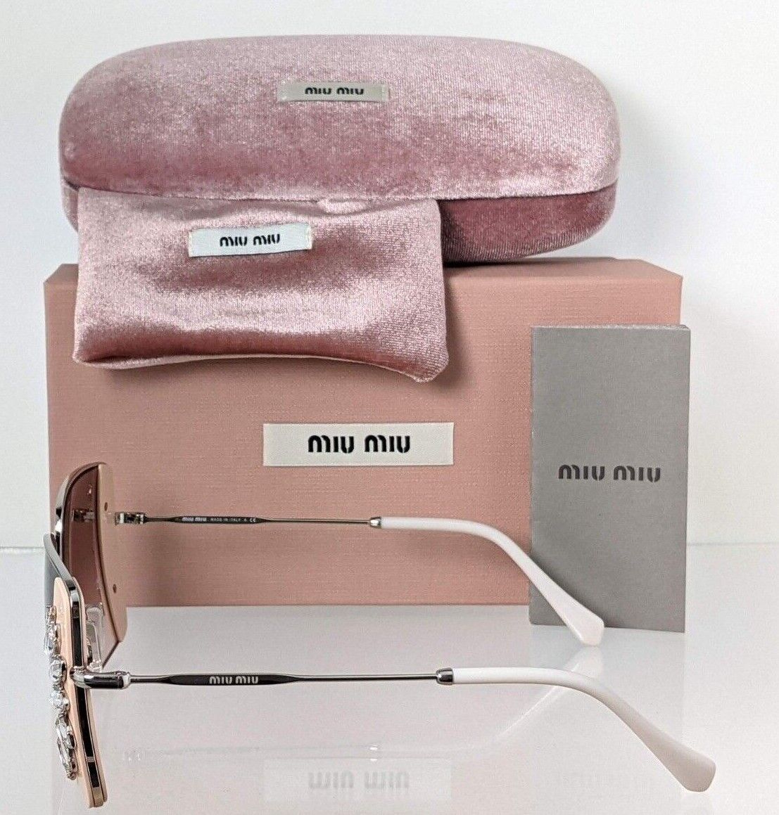 Brand New Authentic MIU MIU SMU 56V 02E - 01C Sunglasses Silver/Pink SMU56V